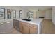 Bright kitchen area featuring an island, wooden cabinets with gold hardware, and modern light fixtures at 3831 N 8Th St, Phoenix, AZ 85014