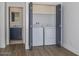 Convenient laundry area with a washer and dryer, complemented by stylish flooring and a peek into the bathroom at 3831 N 8Th St, Phoenix, AZ 85014