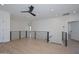 Modern loft area with wood-look flooring, a black ceiling fan, recessed lighting, and sleek black railing at 3831 N 8Th St, Phoenix, AZ 85014