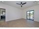 Spacious main bedroom with wood-look floors, ceiling fan, ensuite bathroom, and balcony access through sliding glass door at 3831 N 8Th St, Phoenix, AZ 85014