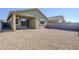 A spacious backyard features a covered patio and low-maintenance gravel landscaping at 40060 W Wade Dr, Maricopa, AZ 85138