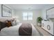 Cozy bedroom with a large bed, neutral decor, and a window offering natural light at 40060 W Wade Dr, Maricopa, AZ 85138