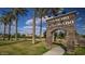 Rancho El Dorado community entrance with mature palm trees at 40060 W Wade Dr, Maricopa, AZ 85138