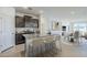 Bright kitchen with granite countertops, stainless steel appliances, and seating at the island at 40060 W Wade Dr, Maricopa, AZ 85138