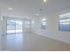 Spacious living room with tile floors, recessed lighting, and sliding glass doors leading to the backyard at 40060 W Wade Dr, Maricopa, AZ 85138
