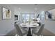 Bright dining area shows a marble table, contemporary lighting, and art at 40060 W Wade Dr, Maricopa, AZ 85138