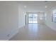 Bright living room with tile floors and sliding glass doors that provide backyard views at 40060 W Wade Dr, Maricopa, AZ 85138