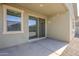 Covered patio with sliding glass door and a window overlooking the yard at 40060 W Wade Dr, Maricopa, AZ 85138