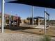 Community playground with climbing structure, shade, picnic tables, and open green space in a Gathering-friendly setting at 40060 W Wade Dr, Maricopa, AZ 85138