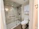 Bathroom featuring a tiled shower with a glass enclosure, toilet, and storage cabinet at 4303 E Cactus Rd # 135, Phoenix, AZ 85032