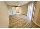 Bedroom featuring a sliding barn door to the bathroom, a ceiling fan, and sliding glass doors at 4303 E Cactus Rd # 135, Phoenix, AZ 85032