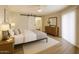Comfortable bedroom featuring a sliding barn door to the bathroom and neutral tones at 4303 E Cactus Rd # 135, Phoenix, AZ 85032