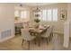 Bright dining room with wood table, modern lighting, and shutters providing natural light at 4303 E Cactus Rd # 135, Phoenix, AZ 85032