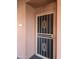 Exterior view of the front door with security screen and decorative design with address number at 4303 E Cactus Rd # 135, Phoenix, AZ 85032