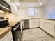 View of the kitchen showcasing stainless steel appliances, granite countertops and bright white cabinets at 4303 E Cactus Rd # 135, Phoenix, AZ 85032