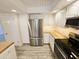 Updated kitchen showcasing granite countertops, stainless steel refrigerator and white cabinets at 4303 E Cactus Rd # 135, Phoenix, AZ 85032