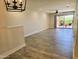 Bright living room with tile flooring, modern light fixture, and sliding glass doors to outdoor space at 4303 E Cactus Rd # 135, Phoenix, AZ 85032