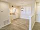 View from living room into open kitchen and dining space with hardwood flooring and modern fixtures at 4303 E Cactus Rd # 135, Phoenix, AZ 85032