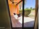View from inside to outside patio with furniture and privacy hedge at 4303 E Cactus Rd # 135, Phoenix, AZ 85032