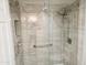 Tiled shower with glass door, shower head, grab bar and storage niche at 4303 E Cactus Rd # 135, Phoenix, AZ 85032