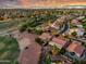 Aerial view of houses in a golf community featuring lush greenery, well-manicured landscaping, and stunning city views at 4906 S Verbena Ave, Gilbert, AZ 85298