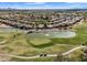 Aerial view of a Primary-planned community on a golf course with lush landscaping and water features at 4906 S Verbena Ave, Gilbert, AZ 85298