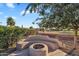 Charming backyard featuring a built-in curved bench and fire pit area for outdoor enjoyment at 4906 S Verbena Ave, Gilbert, AZ 85298
