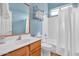 Well-lit bathroom featuring a single sink vanity, toilet, and bathtub with a shower and updated fixtures at 4906 S Verbena Ave, Gilbert, AZ 85298