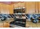 Close-up of the kitchen area showcasing granite counters and stainless steel appliances at 4906 S Verbena Ave, Gilbert, AZ 85298