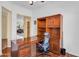 Functional home office with wood floors and built-in shelving at 4906 S Verbena Ave, Gilbert, AZ 85298