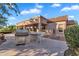 Outdoor kitchen boasts a built-in grill, counter space, and seating, perfect for entertaining at 4906 S Verbena Ave, Gilbert, AZ 85298