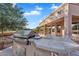 Close-up of the outdoor kitchen featuring a grill and counter, ideal for outdoor cooking and dining at 4906 S Verbena Ave, Gilbert, AZ 85298