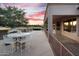 Spacious covered patio with an outdoor kitchen, bar seating, and views of the lush green golf course at 4906 S Verbena Ave, Gilbert, AZ 85298