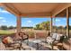 Relaxing outdoor patio with comfortable seating, views of the lush landscaping, and access to the golf course at 4906 S Verbena Ave, Gilbert, AZ 85298