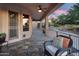 Charming covered patio with tile flooring, comfortable seating, and views of the backyard and desert landscape at 4906 S Verbena Ave, Gilbert, AZ 85298