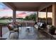 Inviting covered patio with comfortable seating and views of the golf course and colorful sunset at 4906 S Verbena Ave, Gilbert, AZ 85298