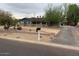 Charming single-story home with mature trees and desert landscaping on an overcast day at 6841 E Vista Dr, Paradise Valley, AZ 85253