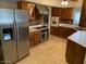 Traditional-style kitchen featuring stainless steel appliances, wooden cabinets, and neutral-toned tile flooring at 6841 E Vista Dr, Paradise Valley, AZ 85253
