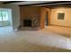 Carpeted living room features a cozy brick fireplace and a seamless transition to the dining area at 6841 E Vista Dr, Paradise Valley, AZ 85253