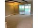 Spacious carpeted living room with sliding glass doors that offer a view of the pool at 6841 E Vista Dr, Paradise Valley, AZ 85253