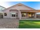Home backyard featuring a patio, gravel landscaping, and a small patch of artificial turf at 689 E Stottler Dr, Gilbert, AZ 85296
