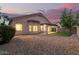 View of the backyard with desert landscaping, a small patch of artificial turf, and a covered patio at 689 E Stottler Dr, Gilbert, AZ 85296
