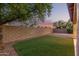 Block wall borders the backyard, which has desert landscaping and a patch of artificial turf at 689 E Stottler Dr, Gilbert, AZ 85296