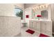 Bright bathroom featuring double sinks, modern lighting, neutral colors, and a walk-in shower at 689 E Stottler Dr, Gilbert, AZ 85296