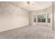 Bright bedroom with carpet, ceiling fan, and windows providing natural light at 689 E Stottler Dr, Gilbert, AZ 85296