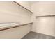 Walk-in closet provides ample storage with shelves, rods, and neutral carpeting at 689 E Stottler Dr, Gilbert, AZ 85296