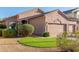 Exterior view of the home with a three-car garage, desert landscaping, and artificial turf at 689 E Stottler Dr, Gilbert, AZ 85296