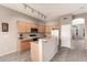 Charming kitchen featuring wood cabinets, a breakfast bar, and track lighting at 689 E Stottler Dr, Gilbert, AZ 85296