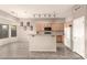 Bright kitchen featuring wood cabinets, tile floors, and an open layout with bar seating at 689 E Stottler Dr, Gilbert, AZ 85296