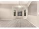 Bright living room with neutral carpet, a bay window, and an arched doorway for seamless flow at 689 E Stottler Dr, Gilbert, AZ 85296